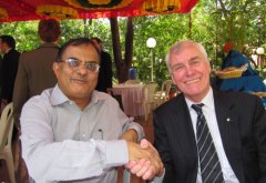 A photo of Ajay Sood and Arthur Carty shaking hands.