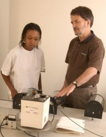 Wayne Pennington (right) demonstrates seismic imaging equipment for a student.