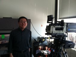 Ximin Gong stands with an instrumented camera, on which he experiments with different graphics tools and algorithms.